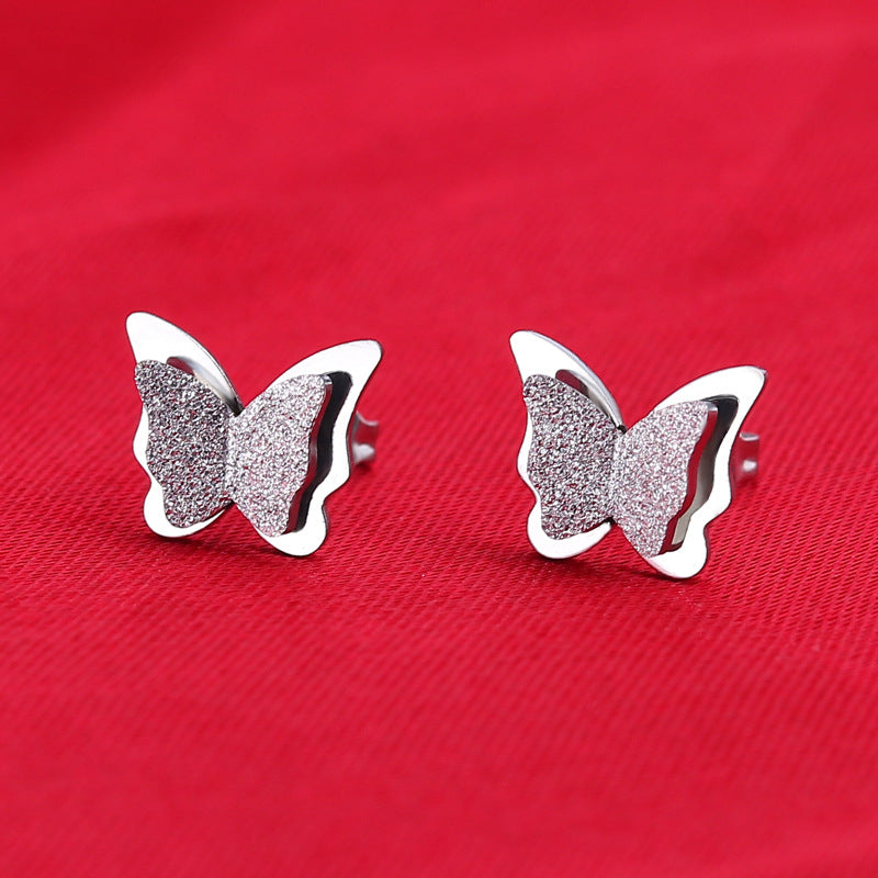 Boucles d'oreilles en titane double papillon givré pressées au sable pour femmes