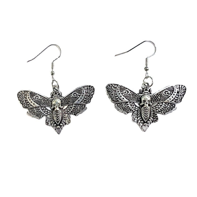 Boucles d'oreilles gothiques à la mode avec crâne et papillon