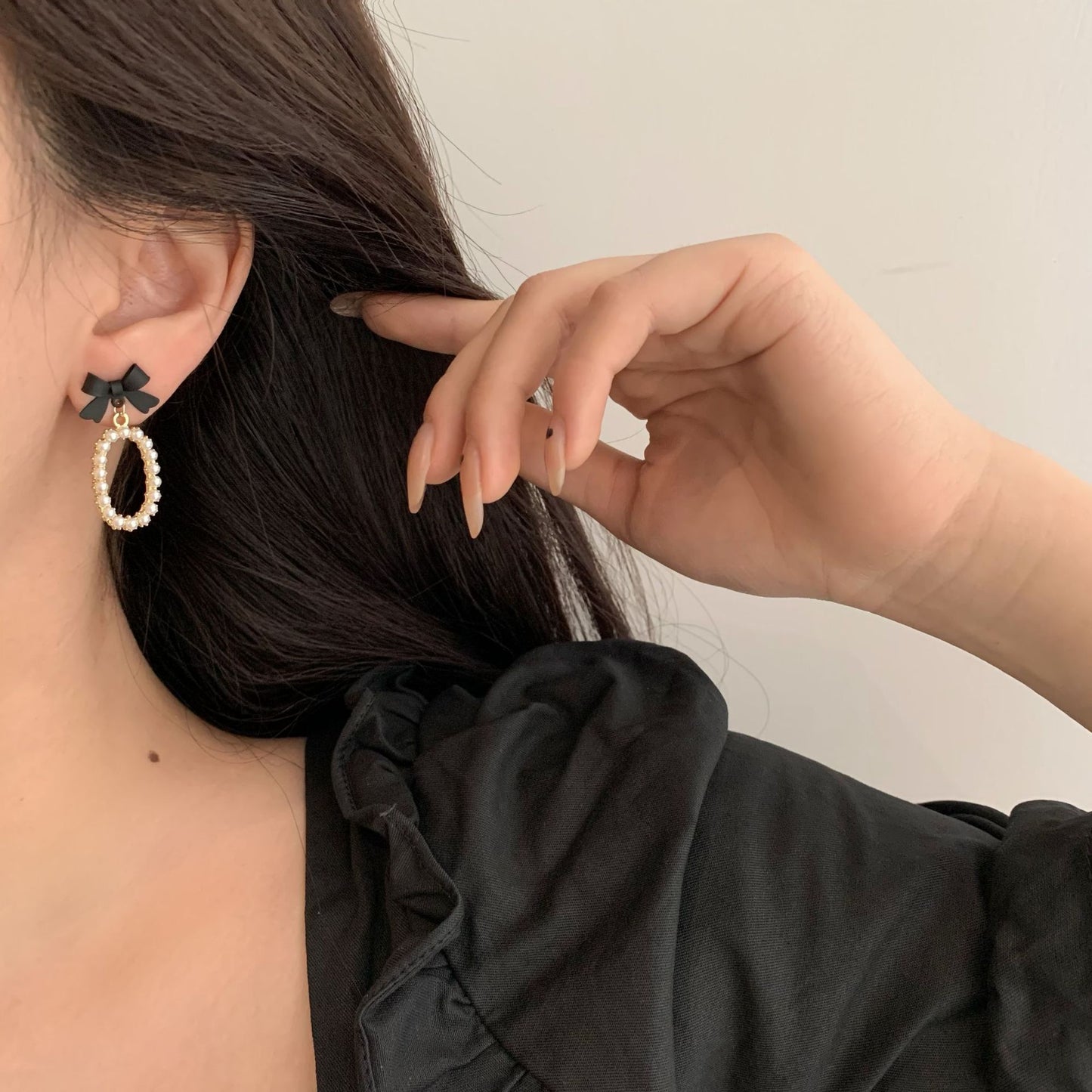 Boucles d'oreilles élégantes et tendance avec nœud noir et perles