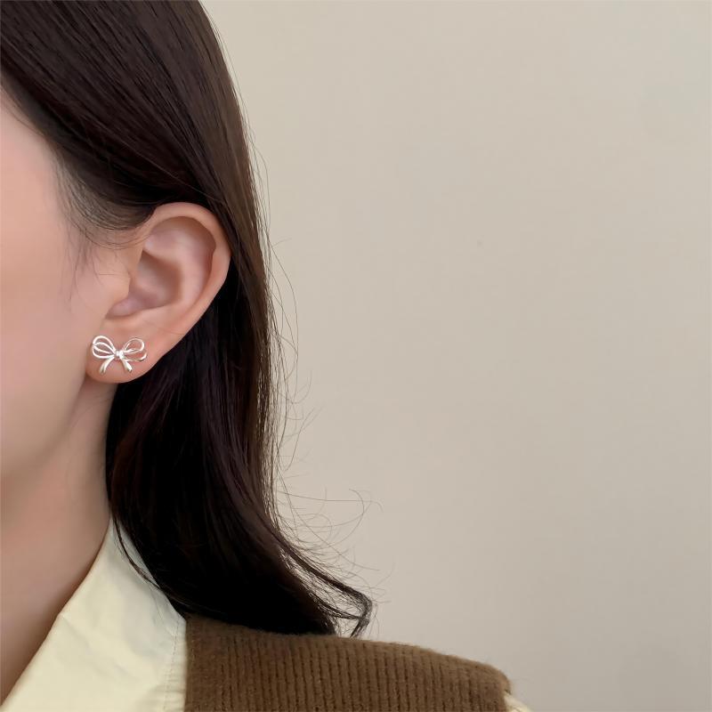 Boucles d'oreilles en métal de haute qualité avec nœud de conception de niche d'aiguille